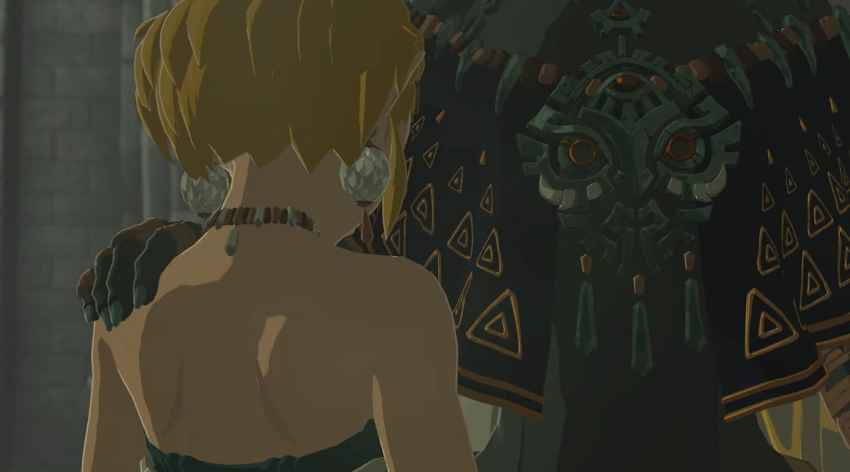 En stillbild från en trailer för The Legend of Zelda: Tears of the Kingdom.  Det visar en lång person som lägger sin hand på Zeldas axel, men vi kan inte se deras ansikte. 