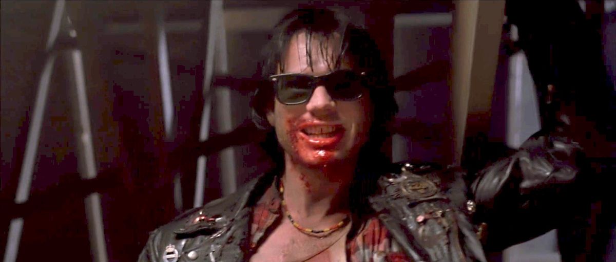 Bill Paxton bleeding out his mouth but also wearing sunglasses in Near Dark