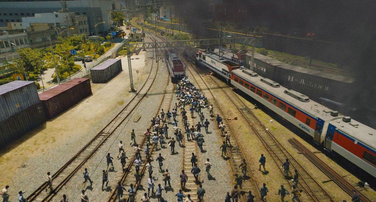Zombies run after a train in Train to Busan