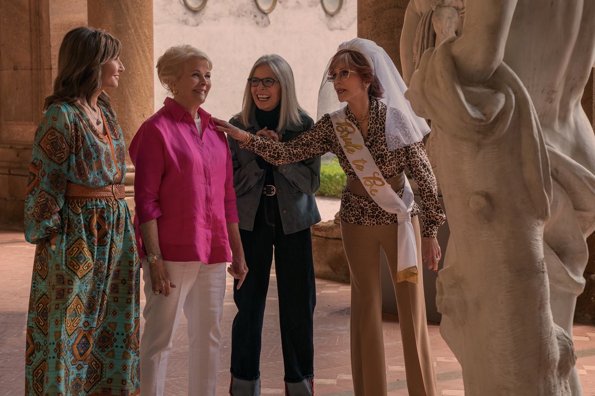 Mary Steenburgen, Candice Bergen, Diane Keaton, and Jane Fonda (wearing a wedding veil) stand in front of a statue in Book Club: The Next Chapter. Fonda puts her hand on Bergen’s shoulder, while the group laughs.
