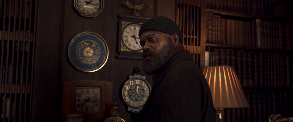 Samuel L. Jackson looks grizzled with scars on his face and a beanie in front of a ton of clocks in Secret Invasion.