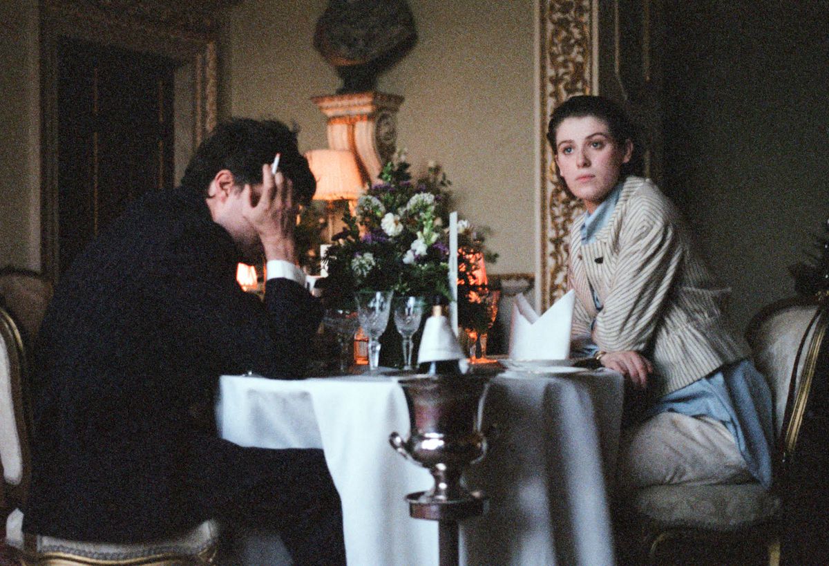 Honor Swinton Byrne’s Julie sits across from her schlubby boyfriend Anthony during a tea at a fancy restaurant in The Souvenir