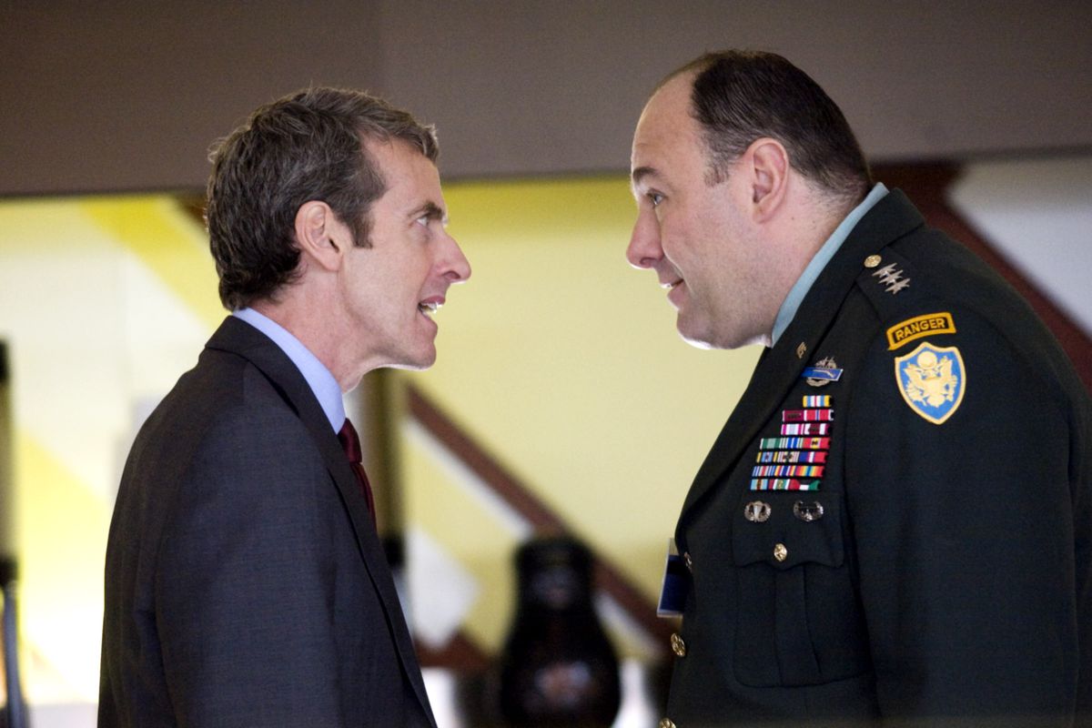 Peter Capaldi and James Gandolfini, dressed as a soldier, face off aggressively