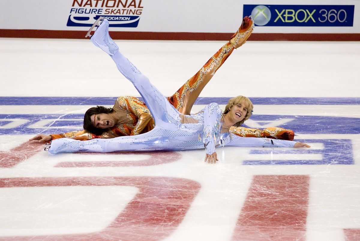 Will Ferrell and Jon Heder, dressed in tight spangly ice-dancing costumes, lie next to each other on the ice and raise their legs in a symmetrical display