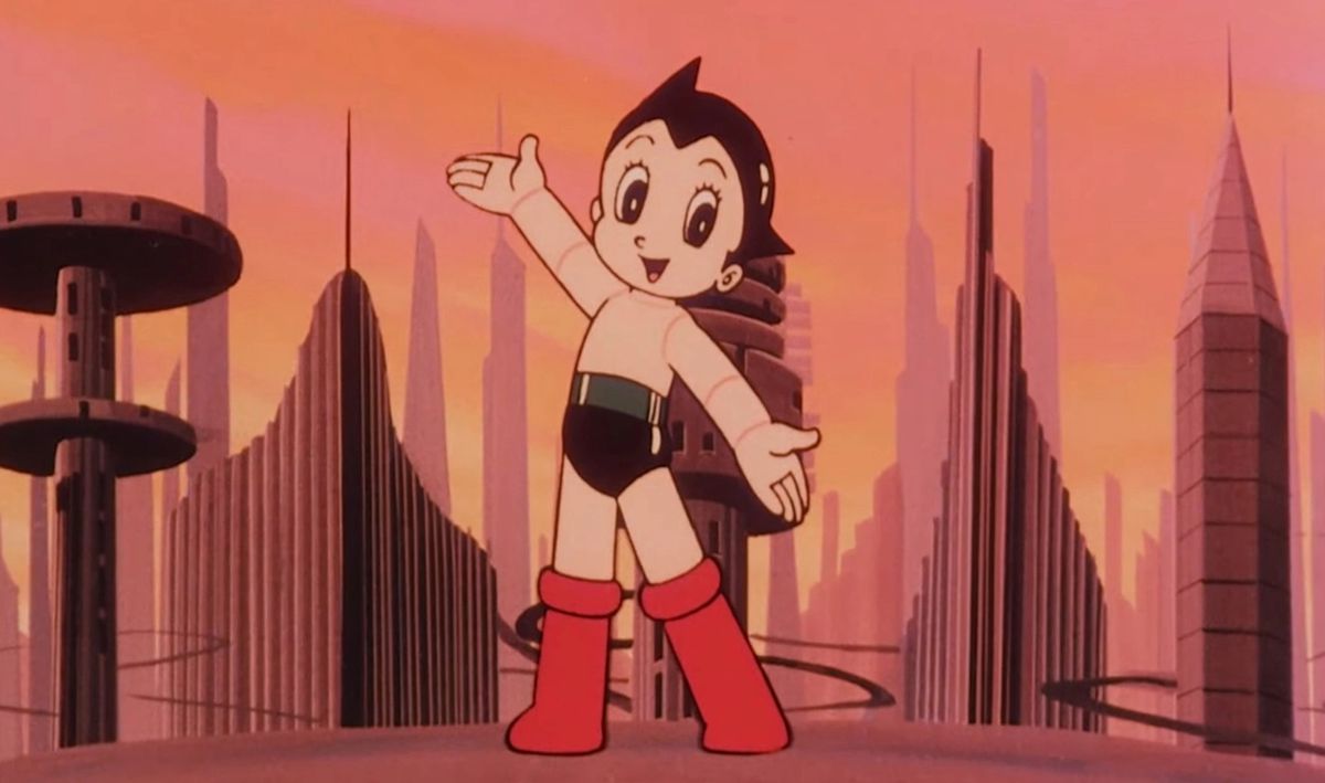 En färgad skärmdump från Astro Boy-tecknad film från 1980, med Astro Boy som står på en avsats med utsikt över en futuristisk stad.