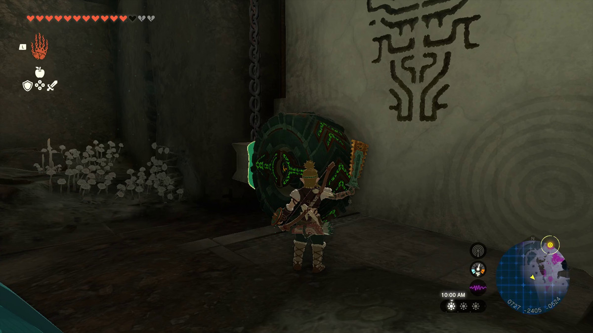 Link takes out a construct weapon and gets ready to whack a wheel on a door in Tears of the Kingdom. The wheel is attached to the left side of a rising door, with the arrows pointing left and the small block is connected to the treads of the wheel.