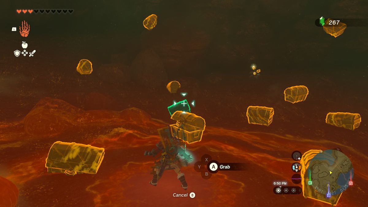 Link använder Ultrahand och siktar mot en kista längst ut i grottan, som sitter fast i marken, i Zelda: Tears of the Kingdom