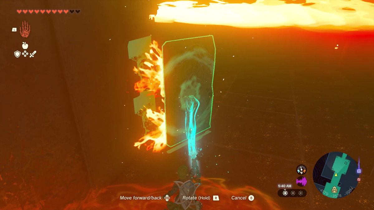 The Legend of Zelda: Tears of the Kingdom Link using Ultrahand to block some flames with a stone panel