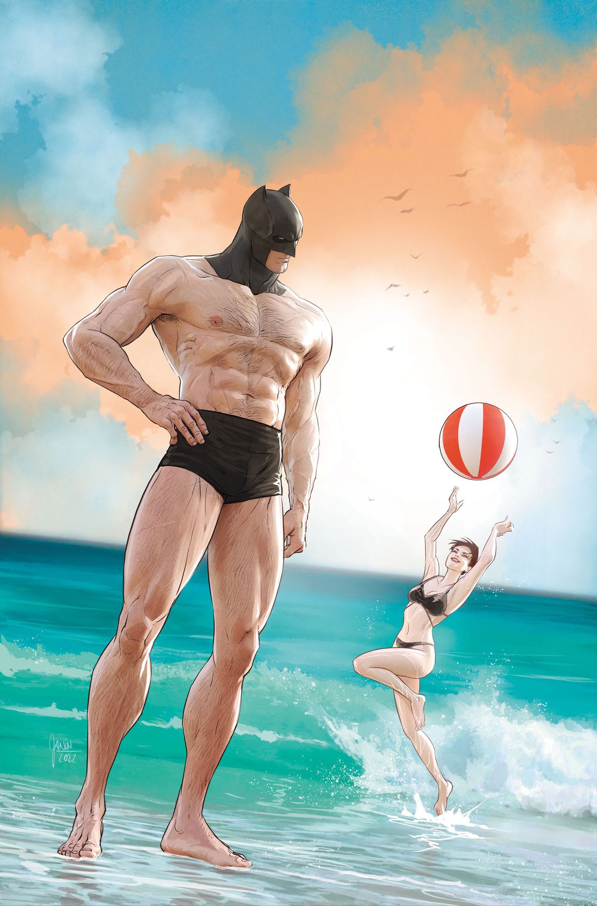 Batman står på stranden iförd en liten uppsättning badbyxor och sin Batman-kåpa.  Bakom honom leker Catwoman med en badboll. 