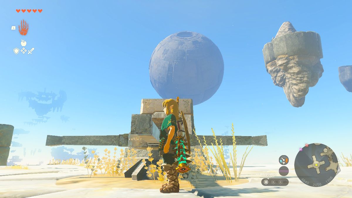 Link stands on a sky island as a sphere looms in the background in Zelda Tears of the Kingdom.