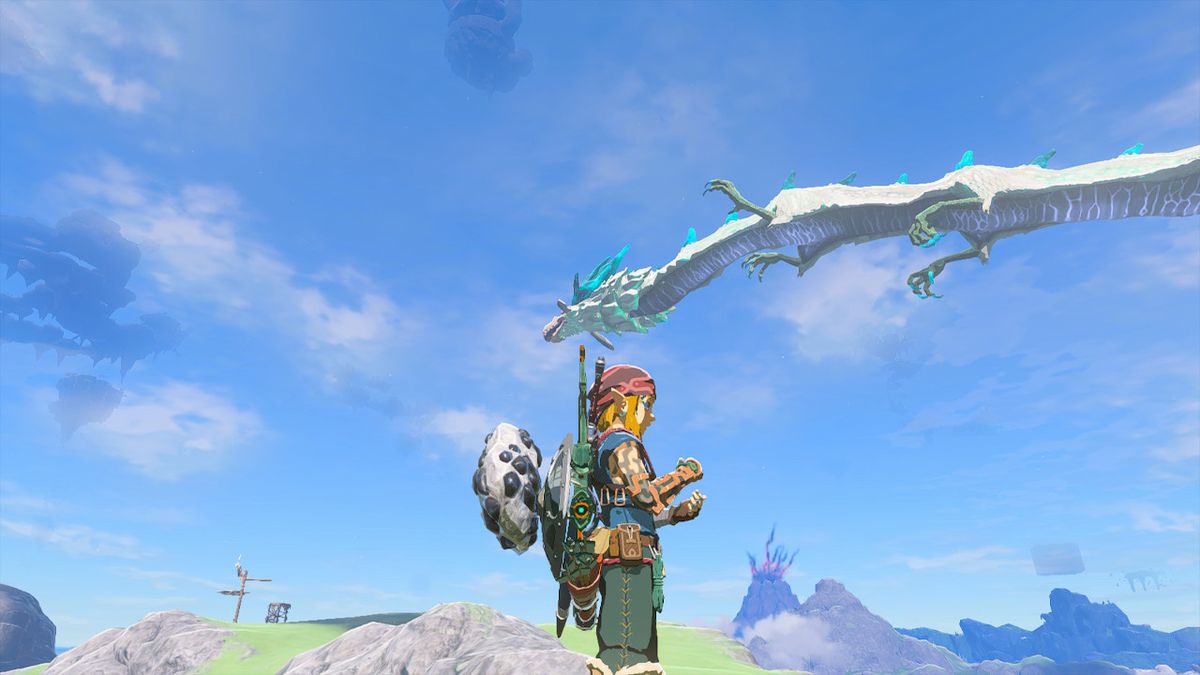 Draken Naydra flyger genom himlen medan Link står på marken under en solig dag i Zelda Tears of the Kingdom.
