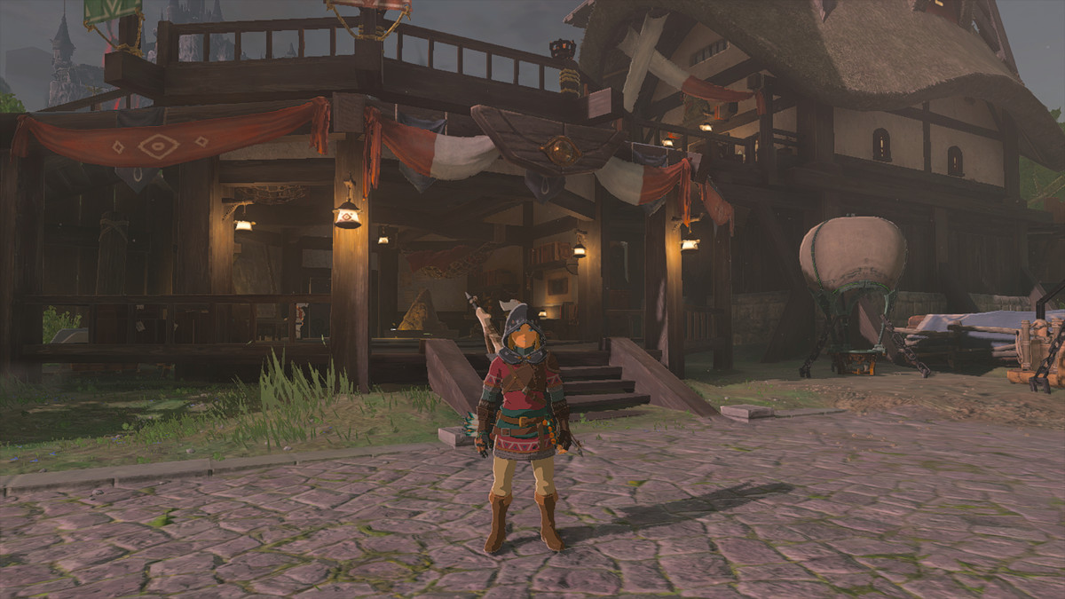 Link wearing the Hylian Armor set in The Legend of Zelda: Tears of the Kingdom. The set layers a tunic that has red and green accents, and leather belts. He wears basic beige pants with it. He looks cute!