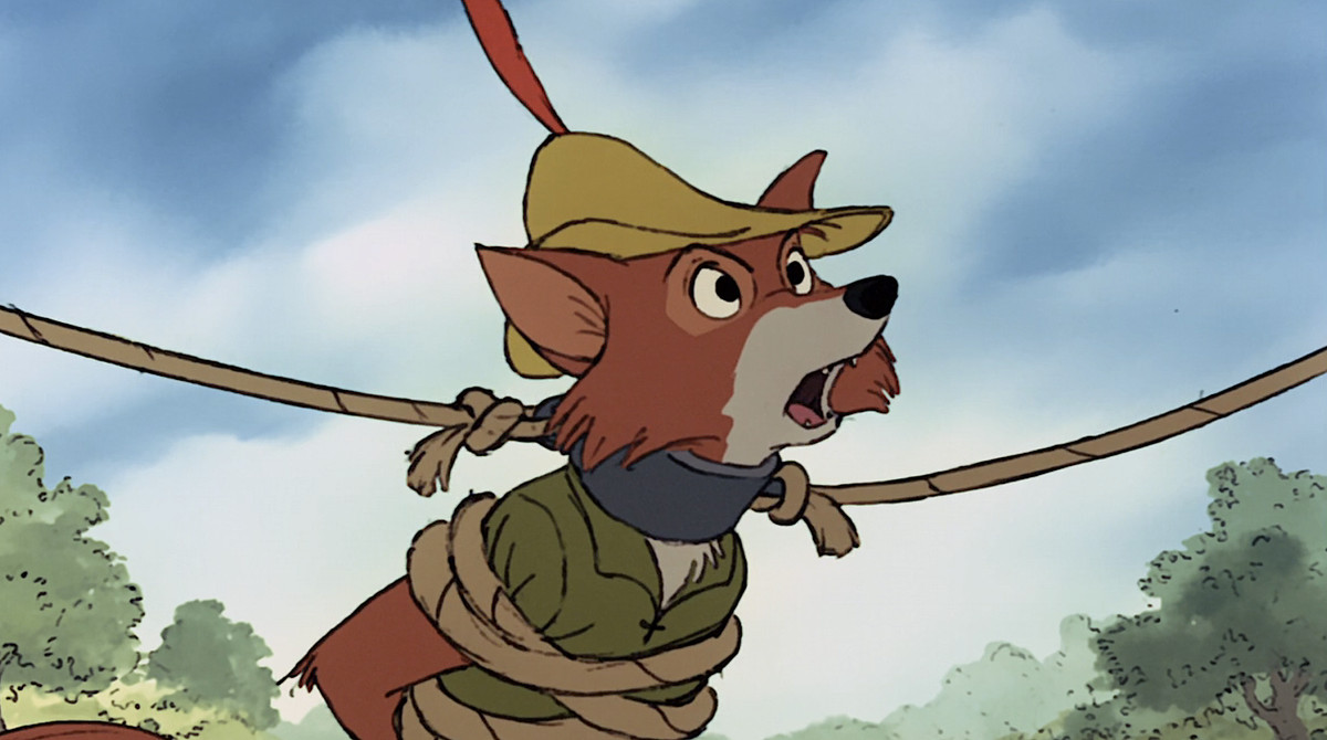 Disneys Robin Hood, en antropomorf räv i grönt, står och ser arg ut med rep lindade runt kroppen och en metallkrage runt halsen i den animerade filmen från 1973
