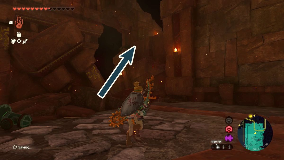 An arrow points up a short wall with a lantern at the top in the Fire Temple in Tears of the Kingdom