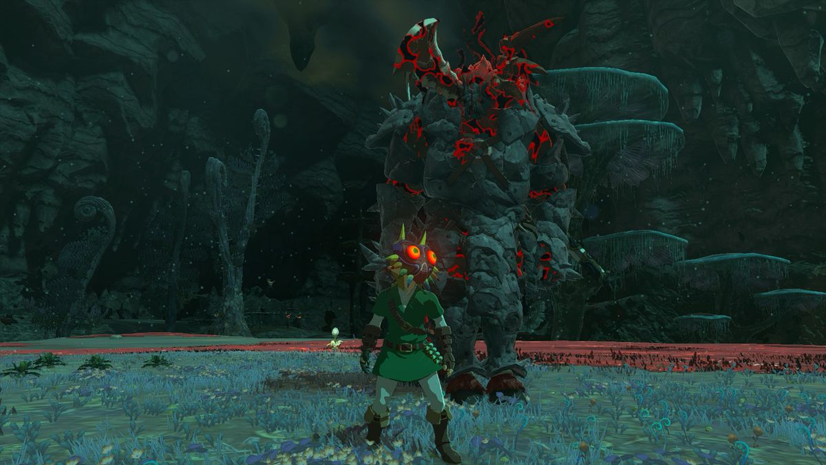 Link wearing Majora’s Mask standing in front of an armored Silver Lynel outside of the Floating Coliseum, which is located in the Depths in The Legend of Zelda: Tears of the Kingdom