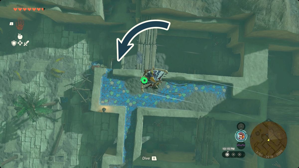The Legend of Zelda: Tears of the Kingdom Länka skärmflygning över Gerudo Town med ingången till grottan nedanför Fashion Passion markerad.