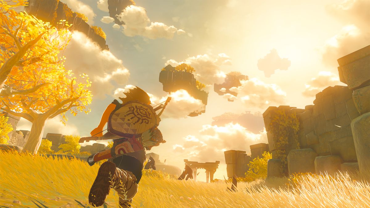 A screenshot of Link running across Hyrule as the sun sets in The Legend of Zelda: Tears of the Kingdom, with the camera angled toward islands floating in the sky