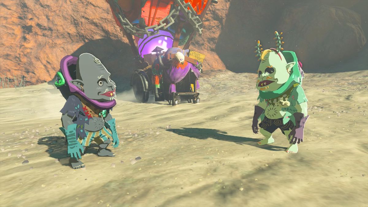 Kilton och Koltin står på sandig mark framför Koltins färgglada stall i The Legend of Zelda: Tears of the Kingdom