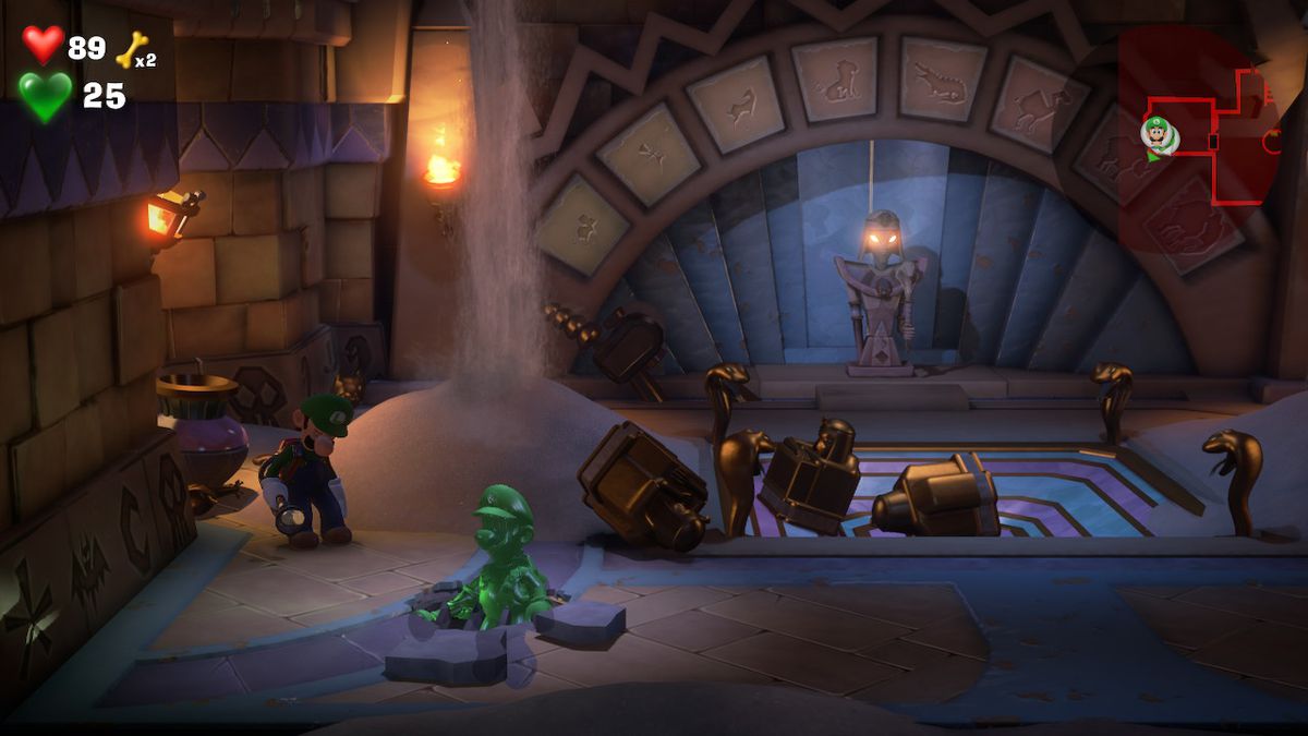 Luigi stands by as Gooigi enters a sewer grate in an Egyptian room in Luigi’s Mansion 3