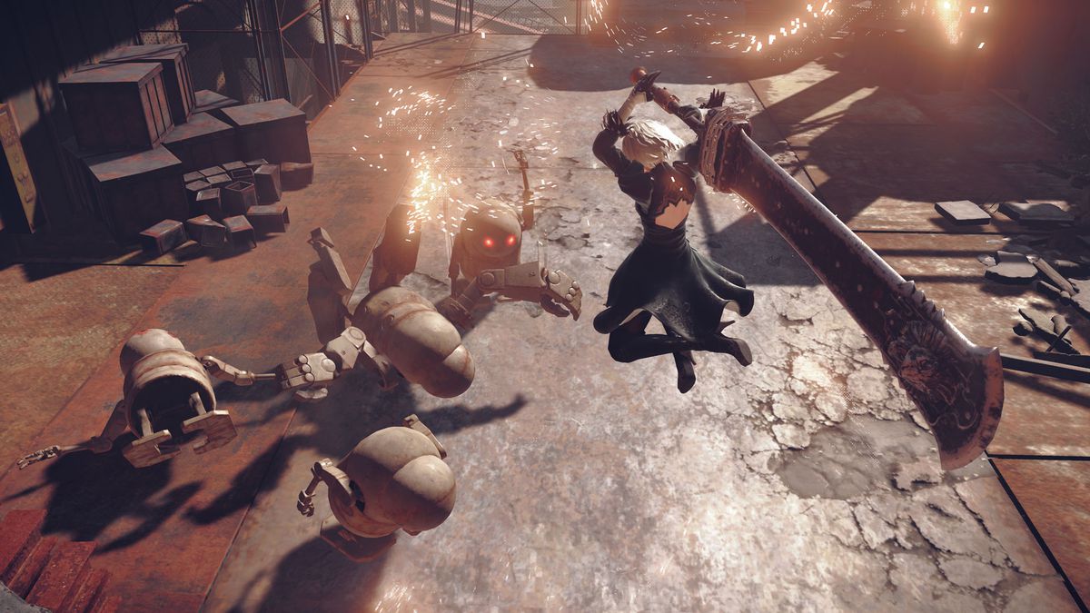 2B swings a giant sword at a robot in Nier Automata