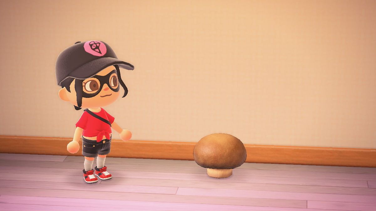 En Animal Crossing-karaktär står bredvid en svamppall