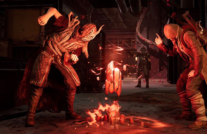 Tre spelare i rest: från asken står runt en eld och använder emotes