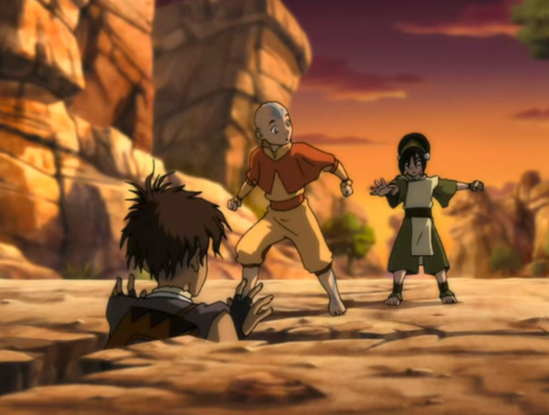 Aang och Toph hittar Sokka fastnat i ett hål, i Avatar: The Last Airbender. 