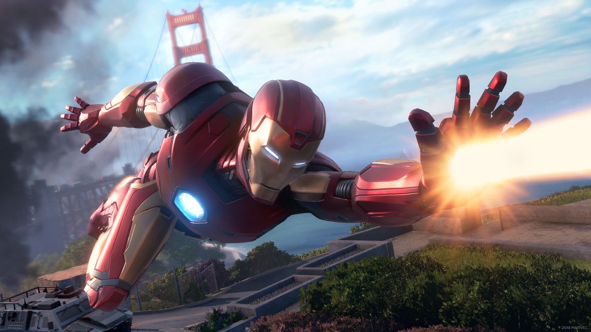 Iron Man flying with the Golden Gate Bridge in the background and firing a beam from his left hand in Marvel’s Avengers