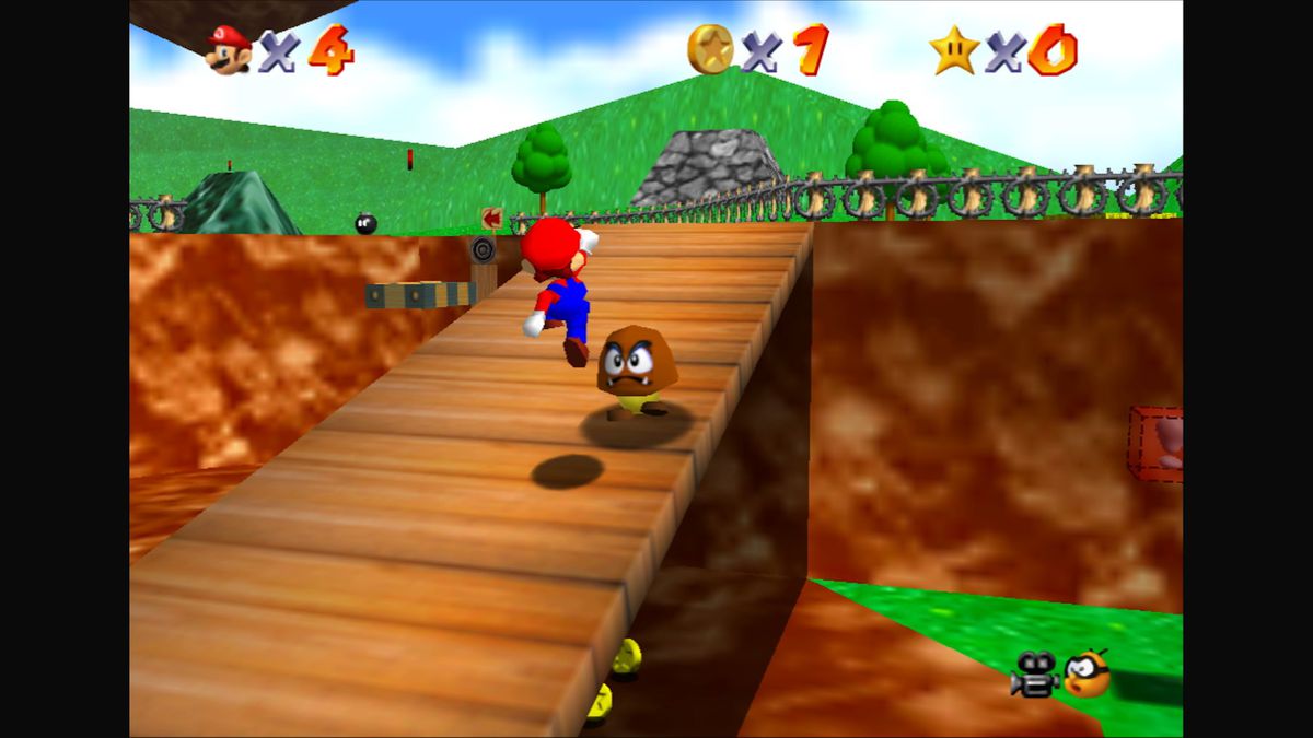 Mario hoppar upp en ramp och siktar mot en goomba i Super Mario 64