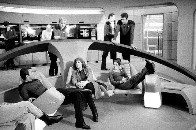 Besättningen av Star Trek: The Next Generation hänger på broens uppsättning. 