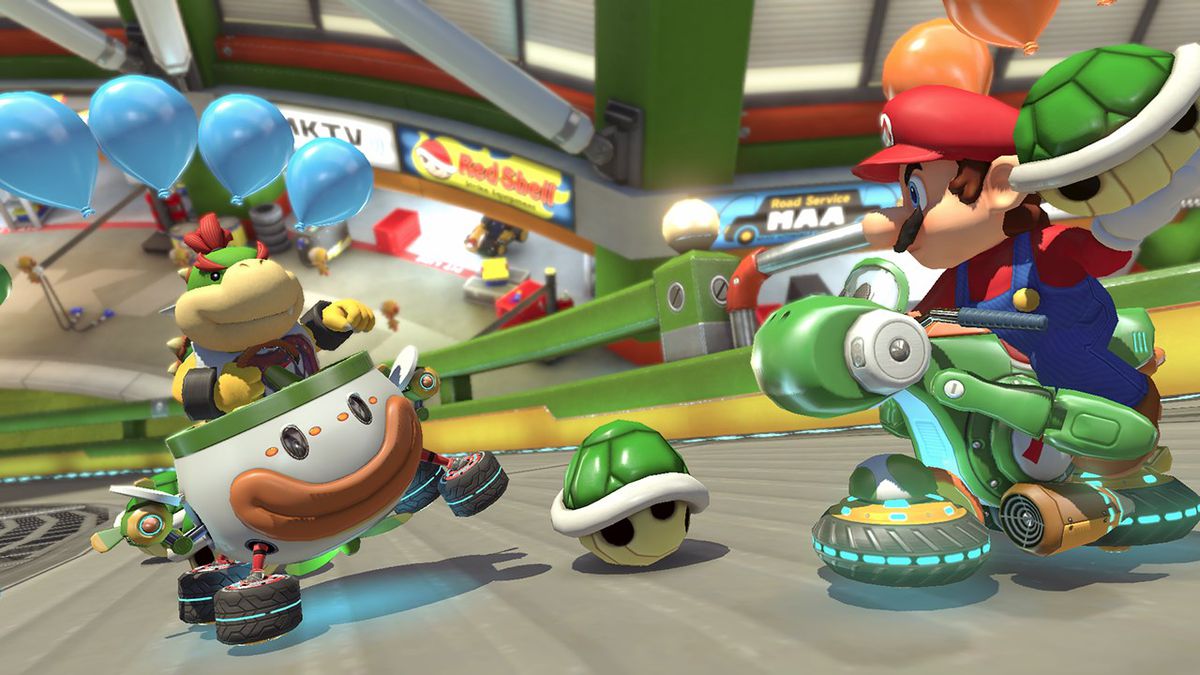 Mario aiming a green shell at Bowser Jr. in Mario Kart 8 Deluxe