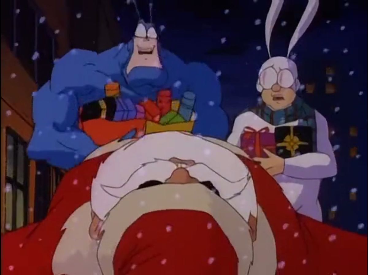 The Tick and Arther look aghast over the body of Santa, in The Tick (1994). 