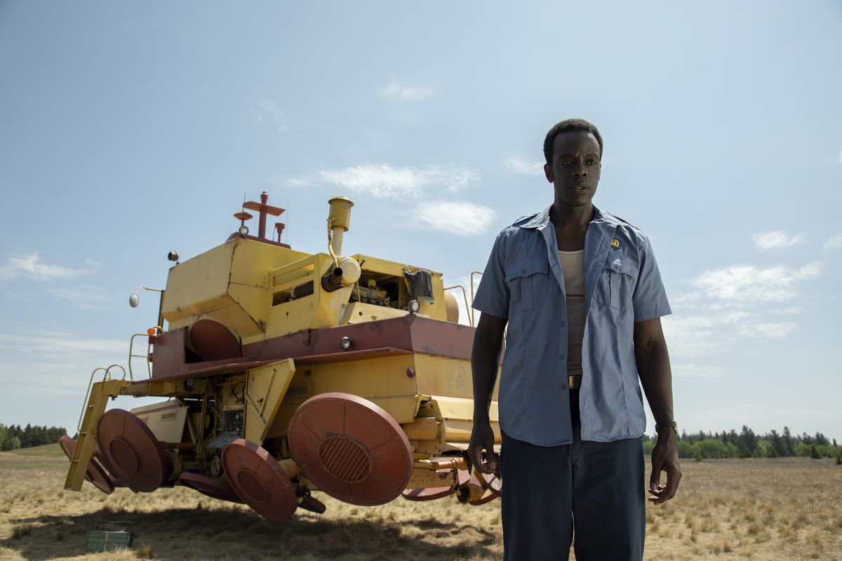 The security guard from the laboratory in front of his pet project, an anti-gravity farm implement.