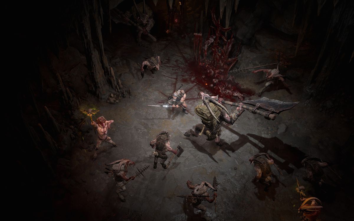 A barbarian fights demons in a cave in a screenshot from Diablo 4