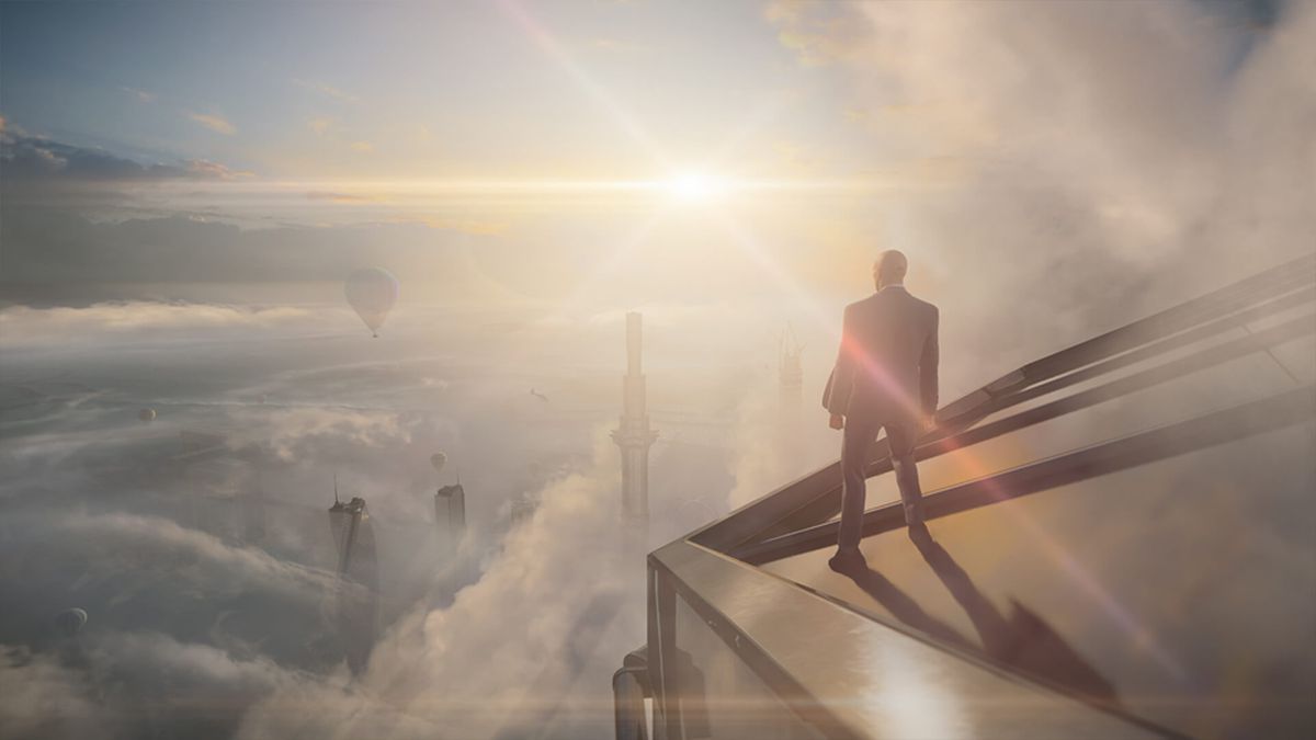 Agent 47 stands in the clouds atop a Dubai skyscraper in Hitman 3