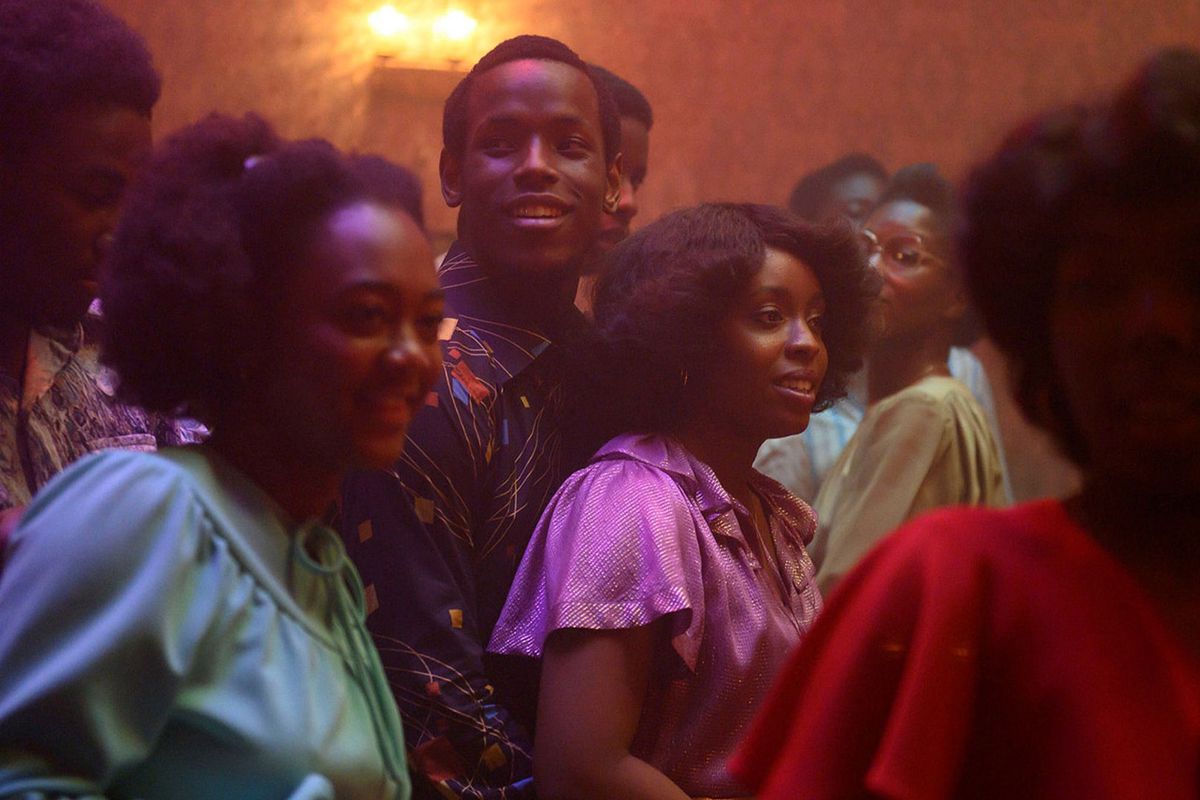 A group of young black people in the 80s dancing in a house