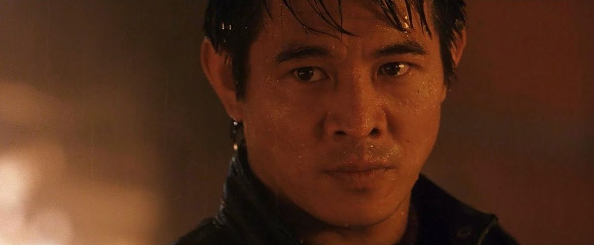 Jet Li staring down his opponent in a ring of fire