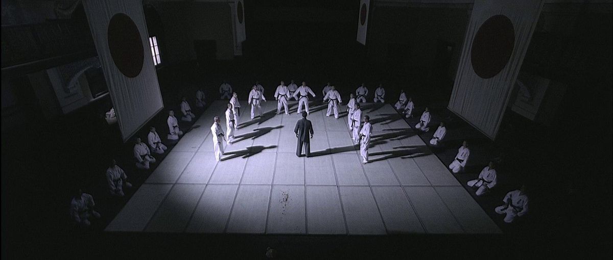 Ip Man gets ready to fight dozens of men clad in white robes in Ip Man.