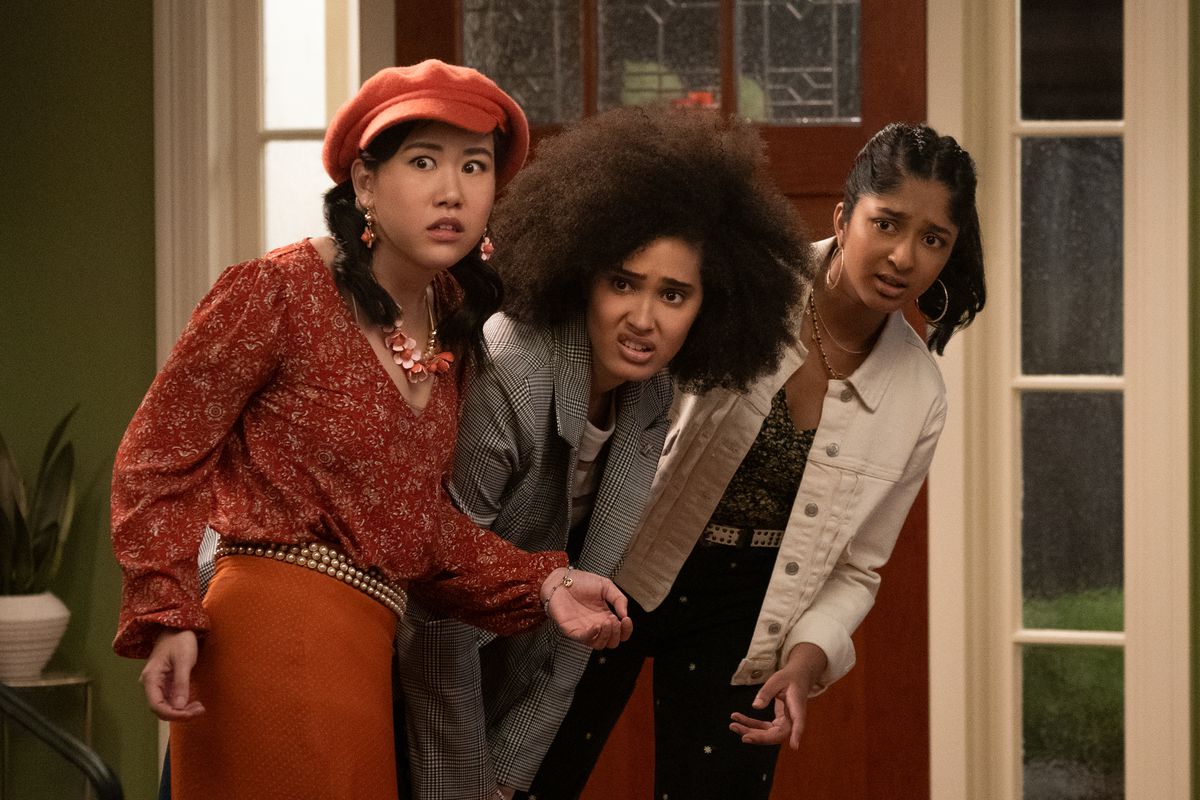 Eleanor, Fabiola, and Devi look skeptically at something ahead in Never Have I Ever season 2.