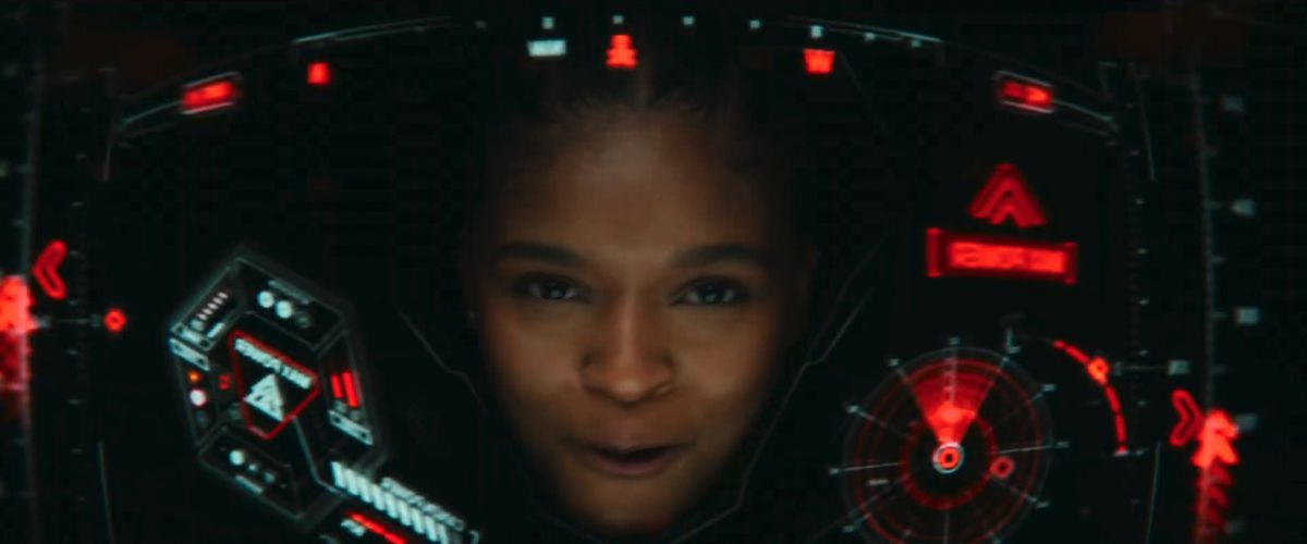 Dominique Thorne as Riri Williams aks Ironheart flying inside Iron Man-esque armor with a HUD display in front of her