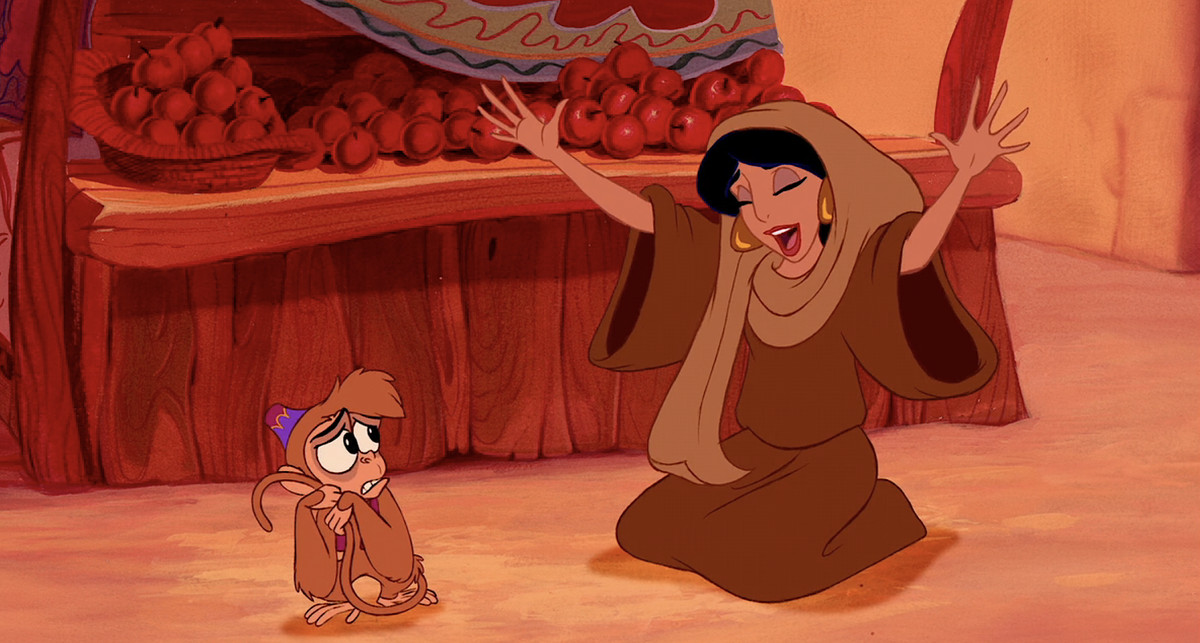 Jasmine in Disney’s Aladdin performs a salaam to a nervous-looking Abu the monkey, while pretending she thinks he’s the Sultan