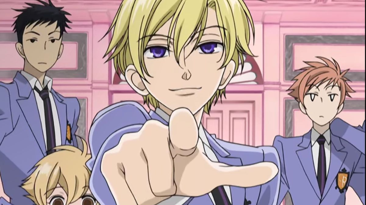Tamaki Suoh points his finger at the off-screen Haruhi Fujioka while other members of the Ouran Host Club stand behind him.