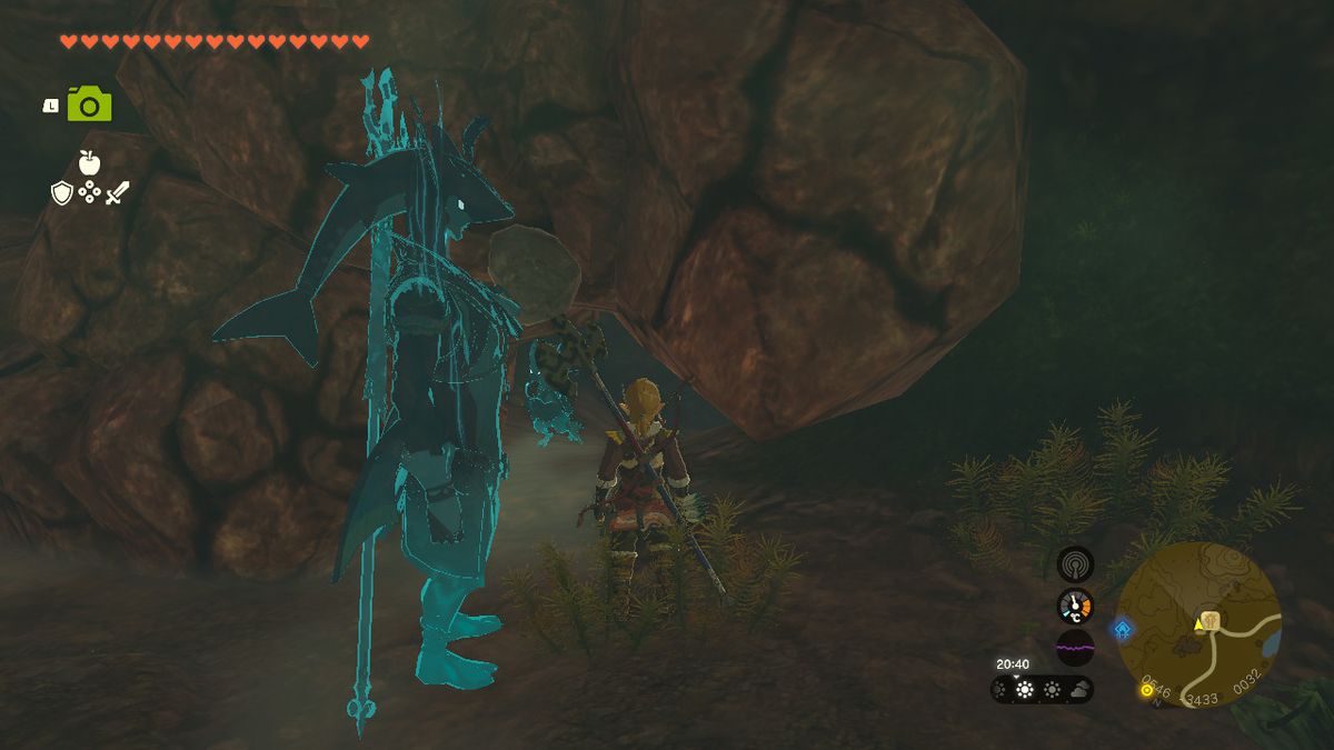 Link står bredvid en sprucken vägg i en grotta på botten av en brunn i Zelda Tears of the Kingdom.