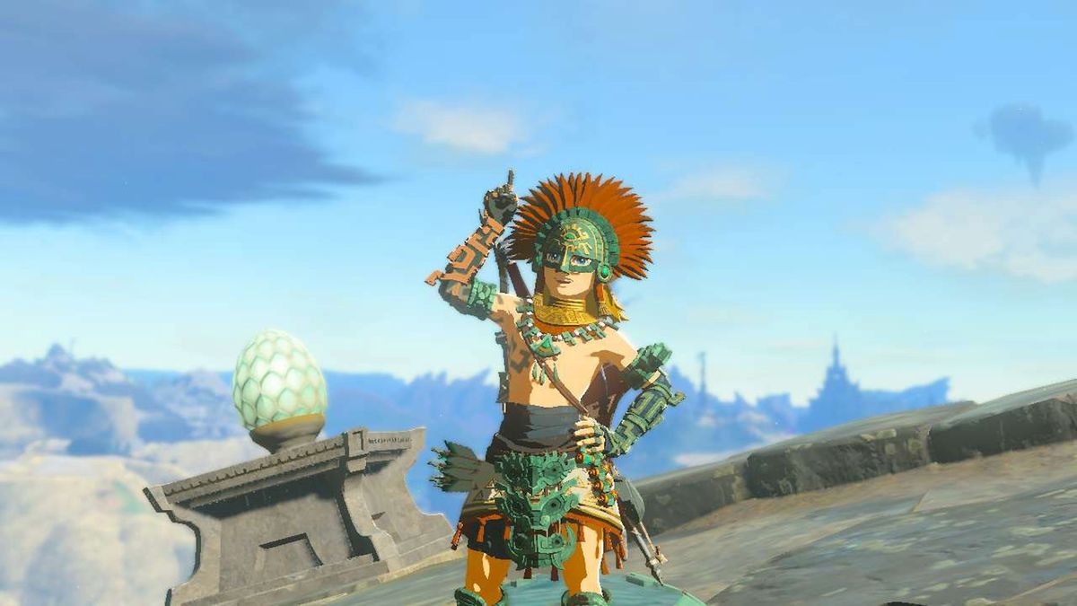 Link stands proudly wearing the Zonaite armor while pointing upwards in Zelda: Tears of the Kingdom