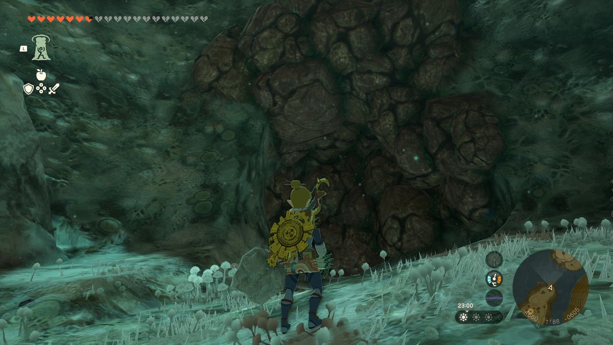 Link stands next a wall of rocks that can crumble in Zelda Tears of the Kingdom.
