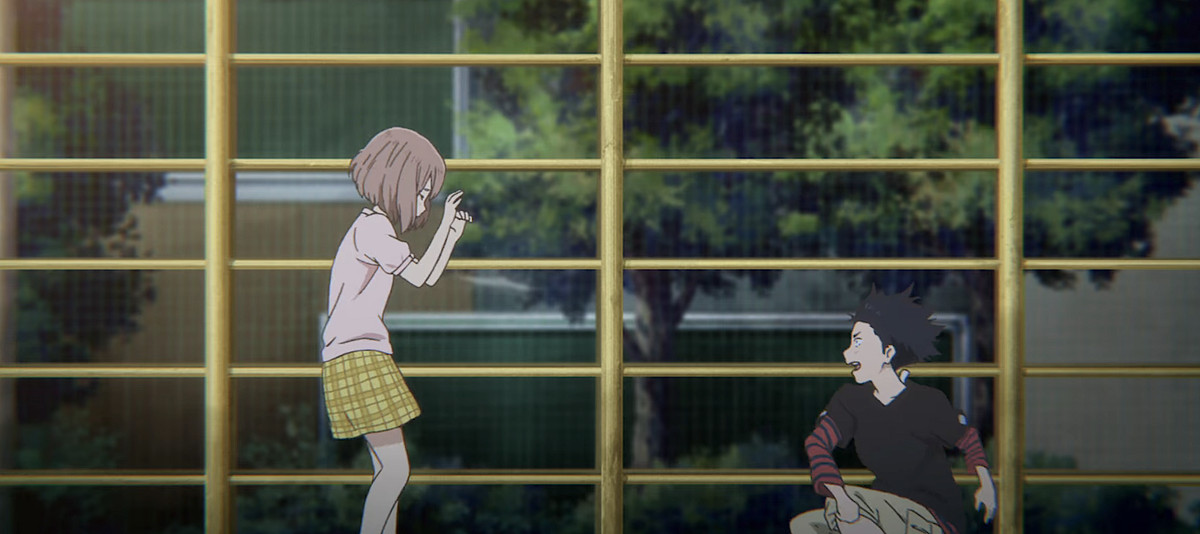 Den taggiga skolpojken Shôya Ishida kastar smuts på den döva klasskamraten Shoko Nishimiya och skriker på henne framför ett rutnät av gult fäktning i en tillbakablicksscen i A Silent Voice