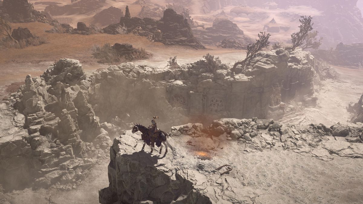 A character rides a horse up to the ledge of a ravine separating an arid landscape from a gloomy expanse in Diablo 4