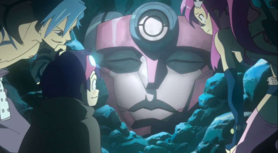 Kamina, Simon, and Yoko stand around the robot head of Gurren in Gurren Lagann