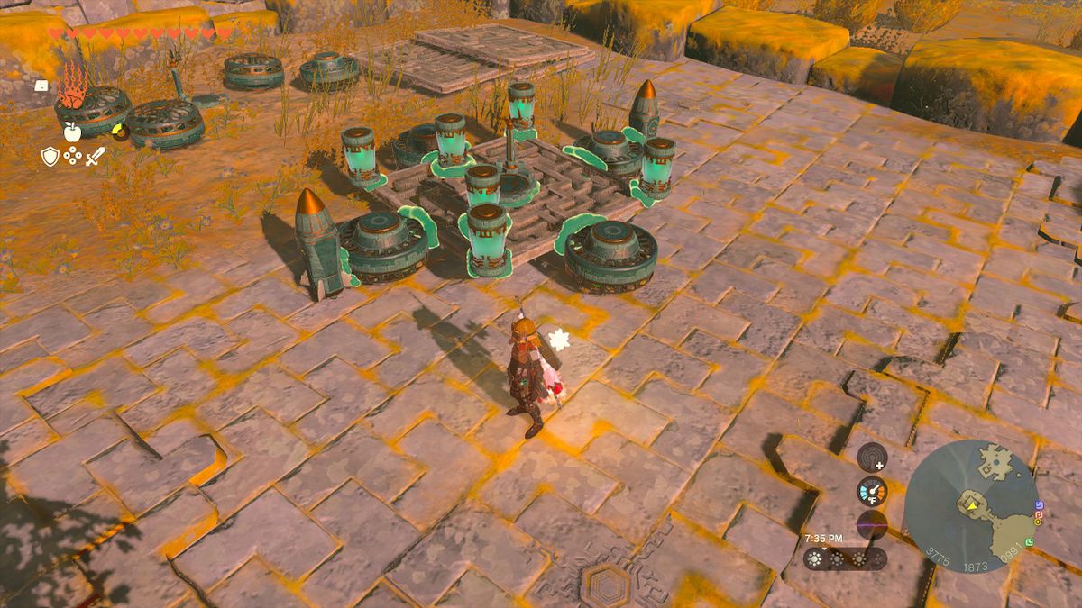 Link stands next to an airborne vehicle built with Zonai devices, which has four fans, six batteries, and two rockets in Zelda: Tears of the Kingdom
