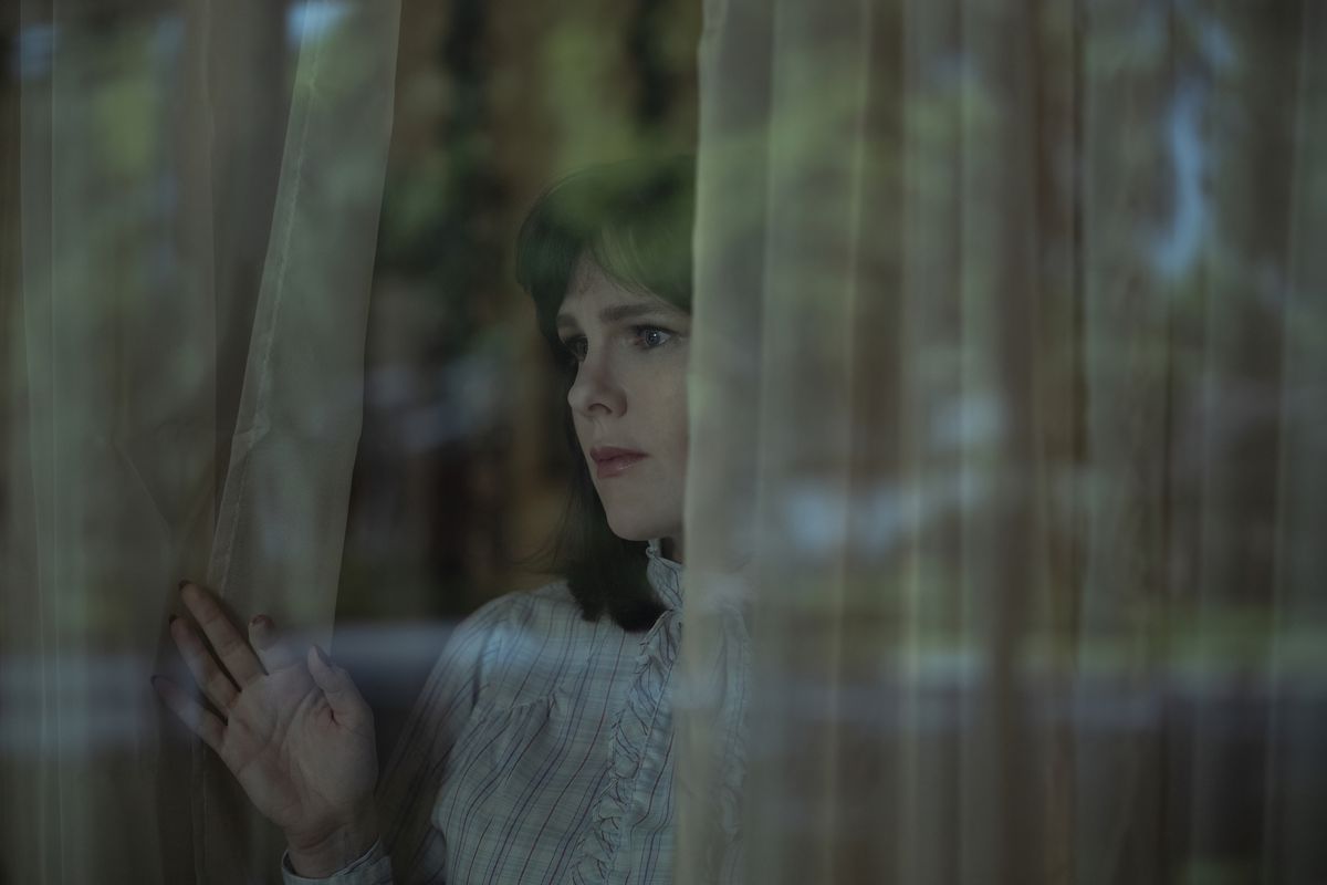 Betty (Lily Rabe) stares out her window in a still from Love & Death